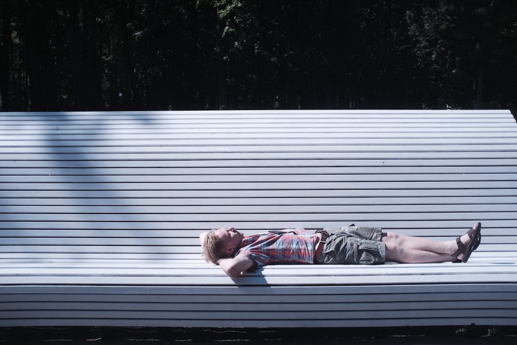 Man sleeping on a bench. 